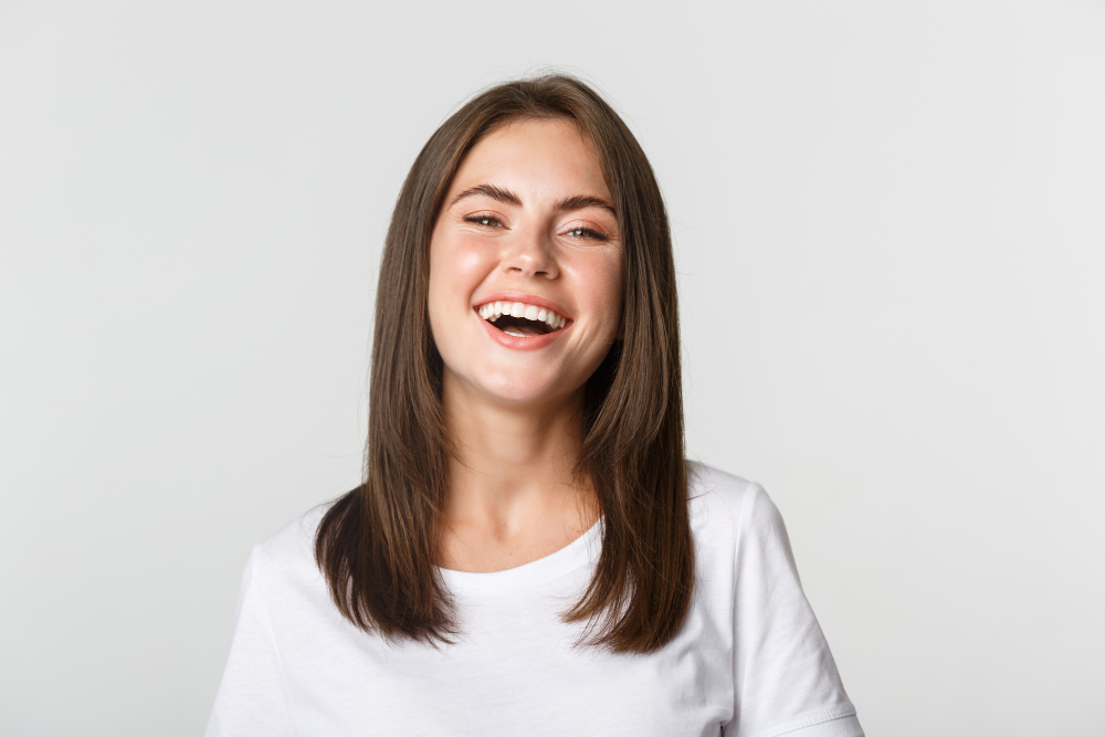close up happy brunette girl white t shirt laughing smiling carefree camera